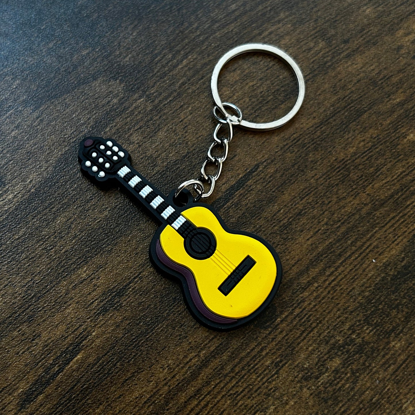 GA-K Yellow and Black Classical Guitar Keychain on a dark wooden surface 